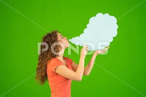 The woman blow a virtual smoke on the green background Stock Photos