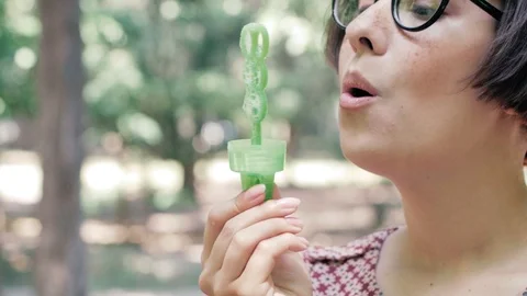 Woman blowing bubbles Stock Footage 110862436
