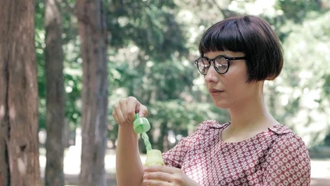 Woman blowing bubbles Stock Footage 110862476