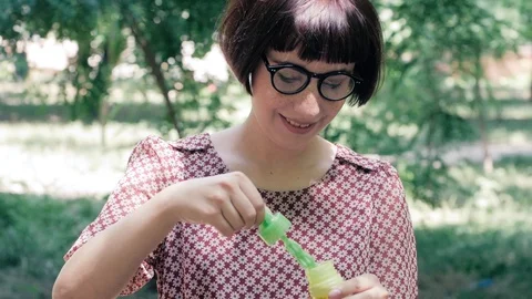 Woman blowing bubbles Stock Footage 110862508