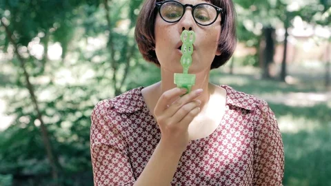 Woman blowing bubbles Stock Footage 110862590