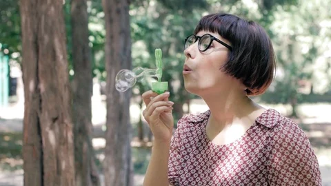 Woman blowing bubbles Stock Footage 110862608