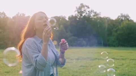 Woman blowing soap bubbles. Stock Footage 342823534