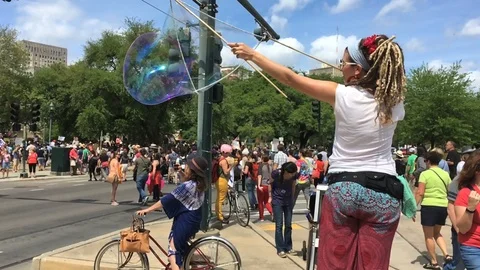 Woman blows bubbles for March for out Lives activists New Orleans, LA Stock Footage 90061663