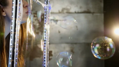 A woman blows bubbles through the frame Stock Footage 88170761