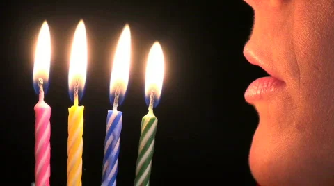 Woman blows out candles - HD Stock Footage