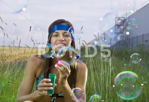 Woman blows soap bubbles Stock Photos