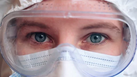 Woman with blue eyes looks at camera and blinks Stock Footage