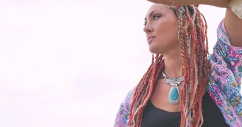 Woman with boho dreadlocks resting leaning on gazebo Stock Footage 290326180