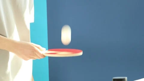 Woman bouncing ping pong ball with racket indoors, closeup Stock Footage 308528203