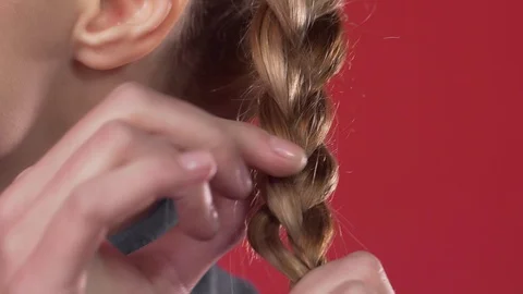 Woman braids a braid, process of making the hairstyle, making of the hairstyle Stock Footage 99636329