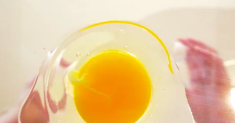 Woman Breaking an Egg in 4K Stock Footage 65445445