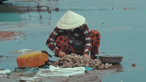 Woman Breaking Shells and Sorting Seafood on Mui Ne Beach  Vietnam Stock Footage 325825307