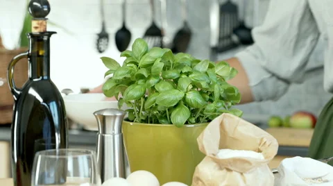 Woman breaks eggs and adding them into flour on the wooden table, dolly shot Stock Footage