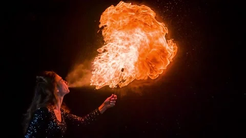 Woman breathing fire in slow motion Stock Footage