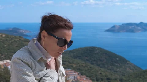 Woman with breathing problems using asthma inhaler outdoors 動画素材 332967442