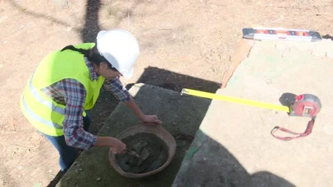 Woman bricklayer works in construction using and preparing cement Видео 270455646