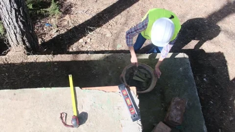 Woman bricklayer works in construction using and preparing cement Видео 270455659