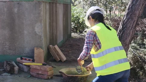 Woman bricklayer works in construction using and preparing cement Vídeos de archivo 270455829