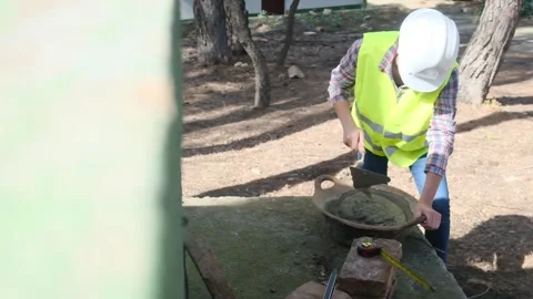 Woman bricklayer works in construction using and preparing cement Видео 270455976