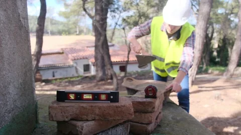 Woman bricklayer works in construction using and preparing cement Vídeos de archivo 270456102