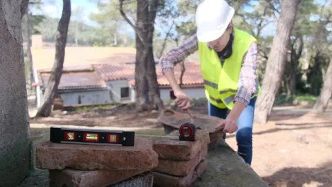 Woman bricklayer works in construction using and preparing cement Vídeos de archivo 270456146