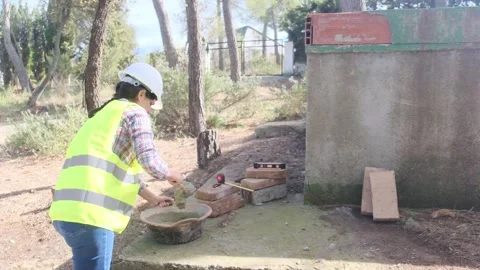 Woman bricklayer works in construction using and preparing cement Vídeos de archivo 270456214
