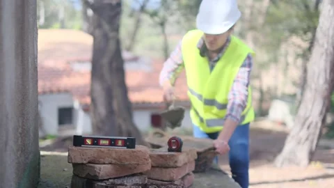 Woman bricklayer works in construction using and preparing cement Vídeos de archivo 270456254