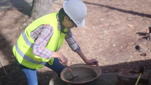 Woman bricklayer works in construction using and preparing cement Stock Footage 270456281