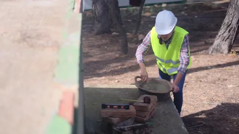 Woman bricklayer works in construction using and preparing cement Vídeos de archivo 270456286