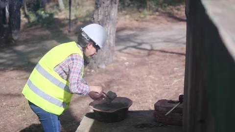 Woman bricklayer works in construction using and preparing cement Vídeos de archivo 270456311