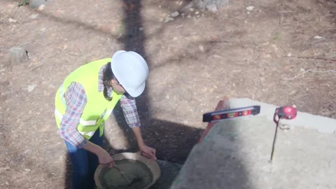 Woman bricklayer works in construction using and preparing cement Vídeos de archivo 270456396