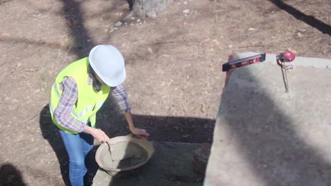 Woman bricklayer works in construction using and preparing cement Vídeos de archivo 270456408