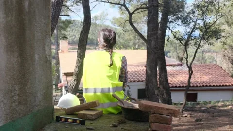 Woman bricklayer works in construction using and preparing cement Vídeos de archivo 270456482