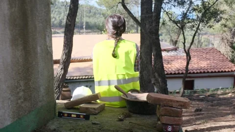 Woman bricklayer works in construction using and preparing cement Vídeos de archivo 270456491