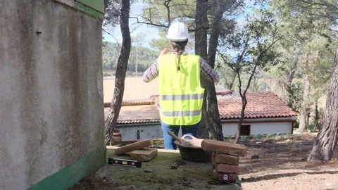 Woman bricklayer works in construction using and preparing cement Vídeos de archivo 270456515