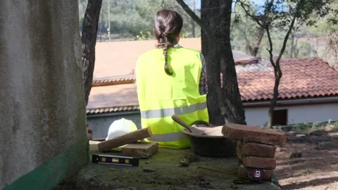 Woman bricklayer works in construction using and preparing cement Видео 270456528
