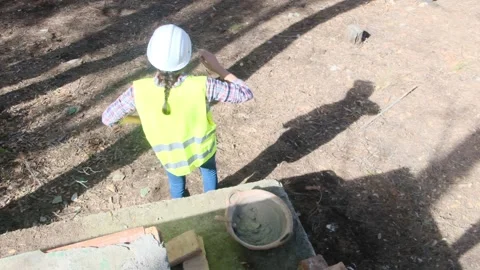 Woman bricklayer works in construction using and preparing cement Vídeos de archivo 270456629