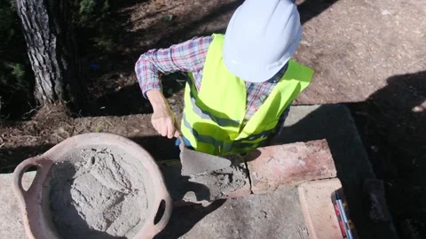 Woman bricklayer works in construction using and preparing cement Vídeos de archivo 270456906