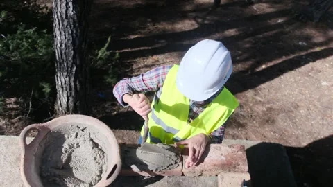 Woman bricklayer works in construction using and preparing cement Видео 270456926