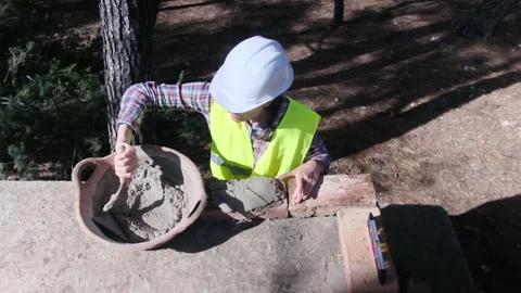 Woman bricklayer works in construction using and preparing cement Vídeos de archivo 270456962