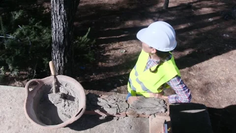 Woman bricklayer works in construction using and preparing cement Stockbeeldmateriaal 270457257