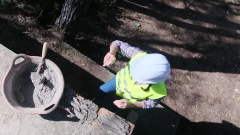 Woman bricklayer works in construction using and preparing cement Vídeos de archivo 270457325