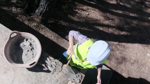 Woman bricklayer works in construction using and preparing cement Vídeos de archivo 270457342