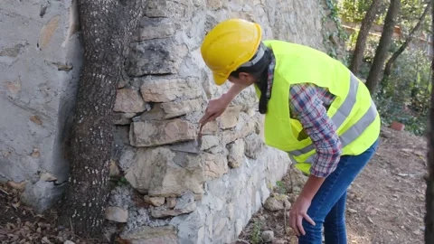 Woman bricklayer works in construction using and preparing cement Видео 270457450