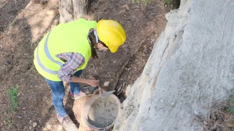 Woman bricklayer works in construction using and preparing cement Видео 270457621