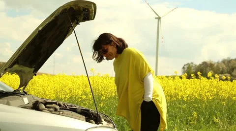 Woman with broken car in countryside Video stock 62862453