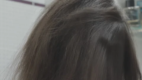Woman with brown, brittle, and split hair is massaging a conditioning oil Video stock 342278954