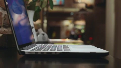 Woman browsing in internet cafe on pc computer laptop typing keyboard message Stock Footage 76886871