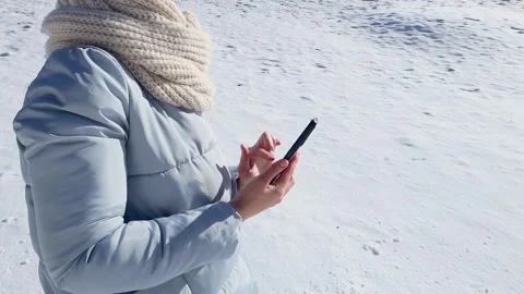 Woman browsing internet using smartphone outdoor in winter Stock Footage 236529926